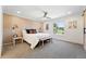 Comfortable bedroom with a wood accent wall, neutral carpet, and natural light at 5616 S Kenton Ct, Englewood, CO 80111