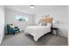 Bedroom with a comfy blue chair, light grey carpets, and headboard made of reclaimed wood at 5616 S Kenton Ct, Englewood, CO 80111
