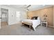 Primary bedroom featuring modern ceiling fan, accent wall, bedside lamps, and cozy bench at 5616 S Kenton Ct, Englewood, CO 80111