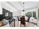Bright dining area features a large window with seating nook and modern light fixture at 5616 S Kenton Ct, Englewood, CO 80111