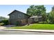 Charming two-story home featuring a well-manicured lawn, mature trees, and a covered front entrance at 5616 S Kenton Ct, Englewood, CO 80111