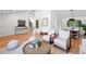 Open-concept living room featuring hardwood floors, neutral decor, and seamless flow to the dining area at 5616 S Kenton Ct, Englewood, CO 80111