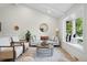Bright living room with vaulted ceilings, modern furniture, large windows, and stylish decor at 5616 S Kenton Ct, Englewood, CO 80111