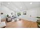Bright living room with vaulted ceilings, modern furniture, large windows, and stylish decor at 5616 S Kenton Ct, Englewood, CO 80111