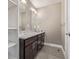 Bathroom featuring double sinks with marble countertops and gray tiled floors at 2008 S Galapago St, Denver, CO 80223