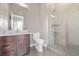 Modern bathroom featuring a glass-enclosed shower, and vanity with granite counter at 2008 S Galapago St, Denver, CO 80223