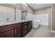 Bathroom featuring dual sinks, marble countertop, soaking tub, and glass-enclosed shower at 2008 S Galapago St, Denver, CO 80223