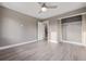 This bedroom boasts a ceiling fan, an open closet and a doorway leading to a wooden staircase at 2008 S Galapago St, Denver, CO 80223