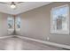 Bright bedroom with three windows providing natural light and light gray wood flooring at 2008 S Galapago St, Denver, CO 80223
