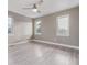 This bedroom features a modern ceiling fan, three windows, and sleek, light-toned floors at 2008 S Galapago St, Denver, CO 80223