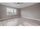 Bright bedroom featuring a modern ceiling fan and a large window at 2008 S Galapago St, Denver, CO 80223