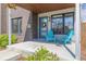 Charming front porch featuring a wreath on the door and two bright blue chairs at 2008 S Galapago St, Denver, CO 80223