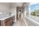 Hallway featuring wood floors, marble countertop kitchenette, and large window with treetop views at 2008 S Galapago St, Denver, CO 80223