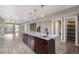 Open concept kitchen featuring island with marble countertop, stainless steel sink, and pendant lighting at 2008 S Galapago St, Denver, CO 80223