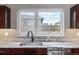 Close up of a kitchen sink with marble countertop, stainless steel sink, and modern fixtures at 2008 S Galapago St, Denver, CO 80223