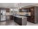 Modern kitchen with stainless appliances, dark wood cabinets, and large center island at 2008 S Galapago St, Denver, CO 80223
