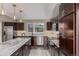 Modern kitchen features stainless appliances, dark cabinetry, pendant lights, and marble countertops at 2008 S Galapago St, Denver, CO 80223