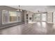 Bright living room with modern ceiling fan and lighting, built-in shelving, and windows at 2008 S Galapago St, Denver, CO 80223