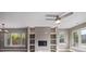 Bright living room boasts a ceiling fan, a fireplace, and large picture windows at 2008 S Galapago St, Denver, CO 80223