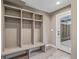 Neutral-toned mud room with custom shelving, coat hooks, and a bench with access to the exterior at 2008 S Galapago St, Denver, CO 80223