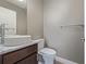 Elegant half bathroom featuring vessel sink, modern faucet, and neutral color palette at 2008 S Galapago St, Denver, CO 80223