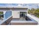 Rooftop deck featuring black plank flooring, a brick railing, and modern siding at 2008 S Galapago St, Denver, CO 80223