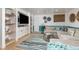 Finished basement boasts built-in shelves, plush seating, and stylish decor for a cozy, inviting space at 6600 E Mississippi Ave # 7, Denver, CO 80224