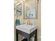 Cozy bathroom featuring a modern sink, mosaic-framed mirror, and stylish fixtures at 6600 E Mississippi Ave # 7, Denver, CO 80224