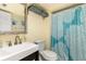 Bathroom featuring a sleek vanity, decorative mirror, and stylish shower curtain at 6600 E Mississippi Ave # 7, Denver, CO 80224