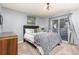 Cozy bedroom with a slider to a private balcony and neutral decor at 6600 E Mississippi Ave # 7, Denver, CO 80224