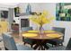 Dining area with a round table, seating for four, and a modern fireplace in the background at 6600 E Mississippi Ave # 7, Denver, CO 80224
