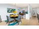 Bright dining area with a round table, seating for four, and view into the modern kitchen at 6600 E Mississippi Ave # 7, Denver, CO 80224