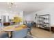 Open dining area connected to a modern kitchen, featuring a round table and stylish decor at 6600 E Mississippi Ave # 7, Denver, CO 80224