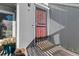 Townhouse entrance featuring a red security door, wood siding, and a welcome mat at 6600 E Mississippi Ave # 7, Denver, CO 80224