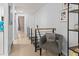 Inviting hallway with modern railing, neutral tones, and a comfortable gray accent chair at 6600 E Mississippi Ave # 7, Denver, CO 80224