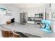 Bright kitchen featuring gray quartz countertops, stainless steel appliances, and white cabinetry at 6600 E Mississippi Ave # 7, Denver, CO 80224