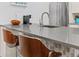 Kitchen counter featuring elegant gray quartz countertops and stylish wooden barstools at 6600 E Mississippi Ave # 7, Denver, CO 80224