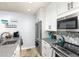 Well-lit kitchen with stainless steel appliances, light countertops, and white cabinetry at 6600 E Mississippi Ave # 7, Denver, CO 80224