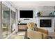 Bright living room showcasing a fireplace, comfortable seating, and natural light from sliding doors at 6600 E Mississippi Ave # 7, Denver, CO 80224