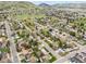 Overhead shot of houses in a neighborhood surrounded by lush green space and rolling hills in the background at 320 Orion St, Golden, CO 80401