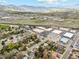 Aerial view of homes near commercial buildings, highway and mountains; ideal for businesses and families at 320 Orion St, Golden, CO 80401