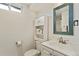 Bathroom featuring a vanity, mirror, and toilet, creating a clean and functional space at 320 Orion St, Golden, CO 80401