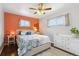 Cozy bedroom featuring wood floors, ceiling fan, large window, and blue floral comforter at 320 Orion St, Golden, CO 80401