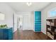 Bedroom featuring wood floors, white walls, and built-in aqua colored storage at 320 Orion St, Golden, CO 80401