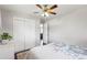 Neutral bedroom showcasing wood floors, a ceiling fan, closet doors, and ample lighting at 320 Orion St, Golden, CO 80401