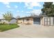 A cozy single-story brick home with a lush green lawn, mature tree and attached garage at 320 Orion St, Golden, CO 80401