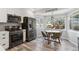 Eat-in kitchen features stainless appliances, tile backsplash, wood floors, and a breakfast nook at 320 Orion St, Golden, CO 80401