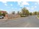 Welcome to Colorado Mills, a shopping destination with a brown monument sign along a street with a gray car at 320 Orion St, Golden, CO 80401