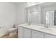 Well-lit bathroom featuring a double sink vanity, quartz countertop, and tiled shower-tub combination at 449 S Salida St, Aurora, CO 80017
