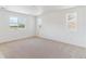 Large bedroom with neutral carpeting, and three large windows providing ample natural light at 449 S Salida St, Aurora, CO 80017